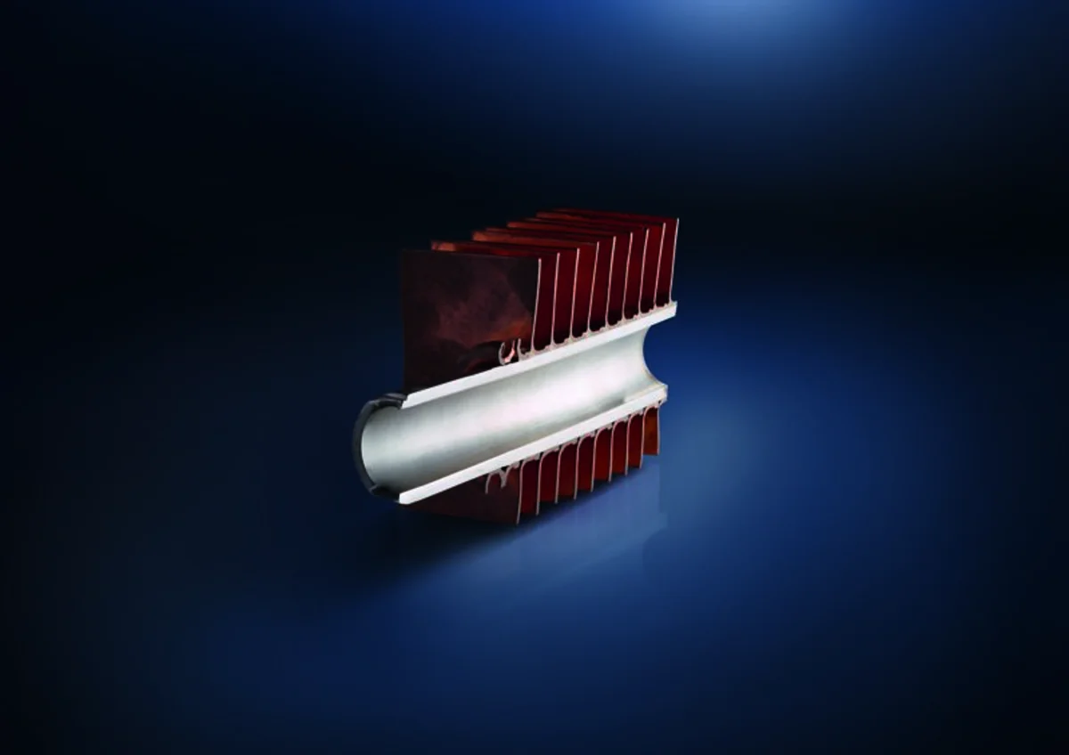 Soldered part with copper on a dark blue surface.
