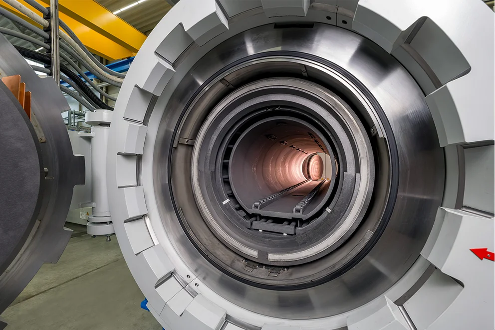 Close-up view into a graphite purification furnace showing concentric cylindrical heating elements.