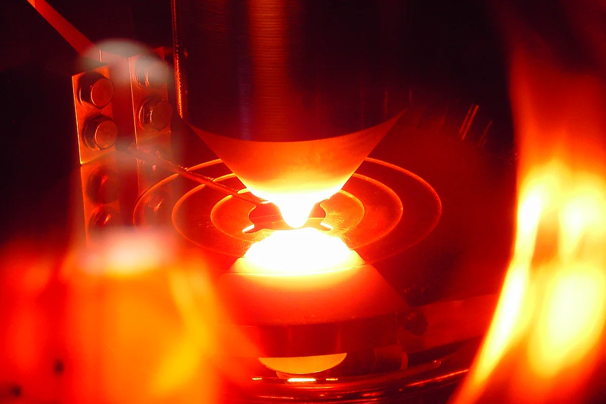 View into a float‑zone crystal growth chamber showing the molten silicon zone during processing