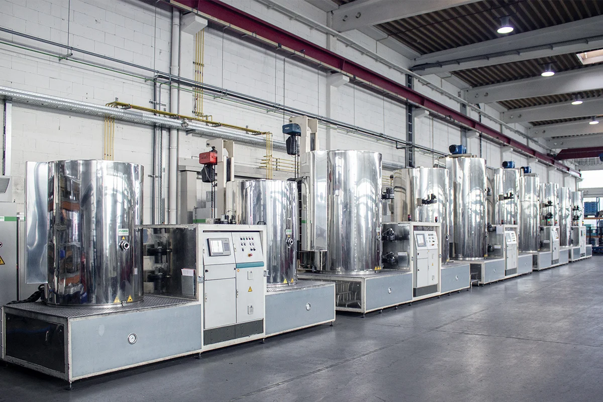 Multiple PulsPlasma® nitride treatment systems aligned in a production facility showing piping and control panels
