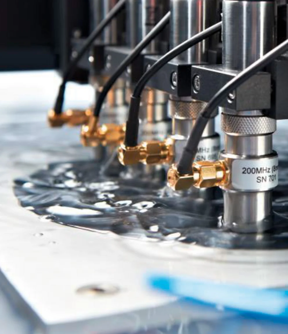 Array of scanning acoustic microscopy (SAM) transducers aligned above a sample surface for high‑precision, non‑destructive inspection.