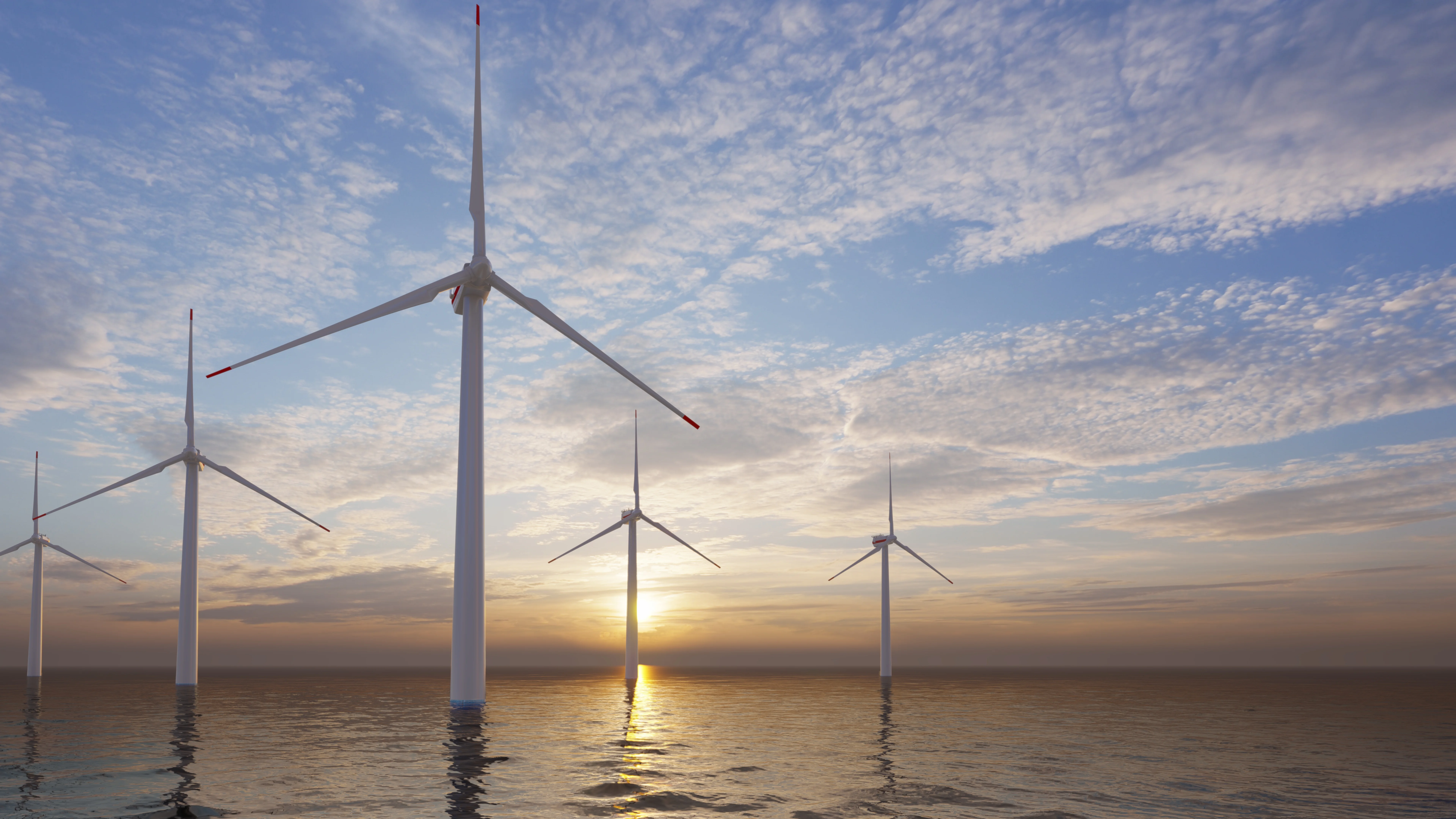 offshore wind turbines in front of a sunset
