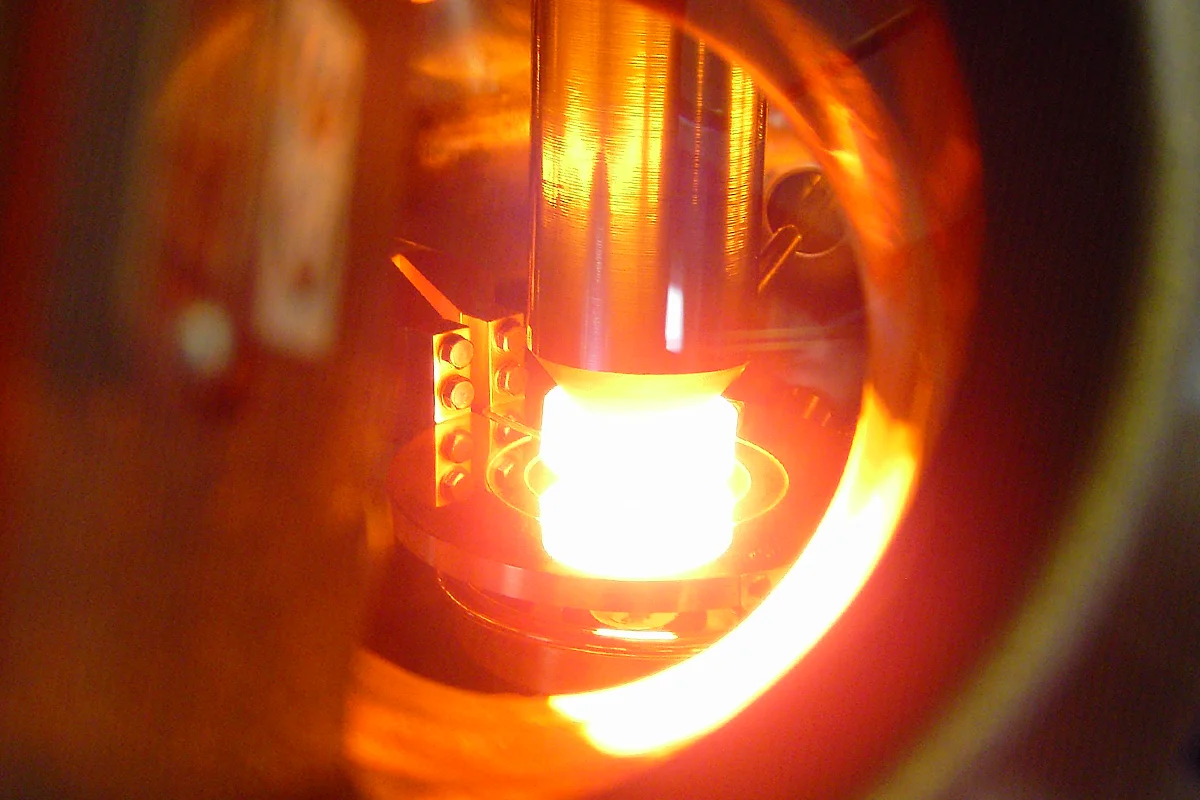 View into a float‑zone crystal growth chamber showing the molten silicon zone during processing