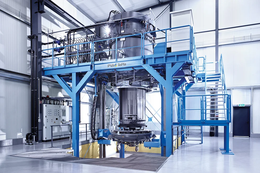 Graphite purification system mounted on a raised support platform in an industrial facility