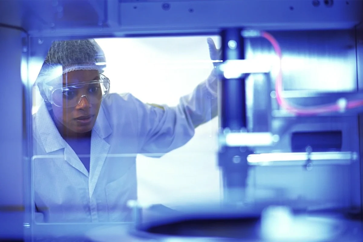 Scientist in protective eyewear observes a stress measurement process in a clean room environment