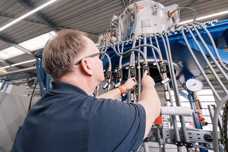 Worker adjusts components
