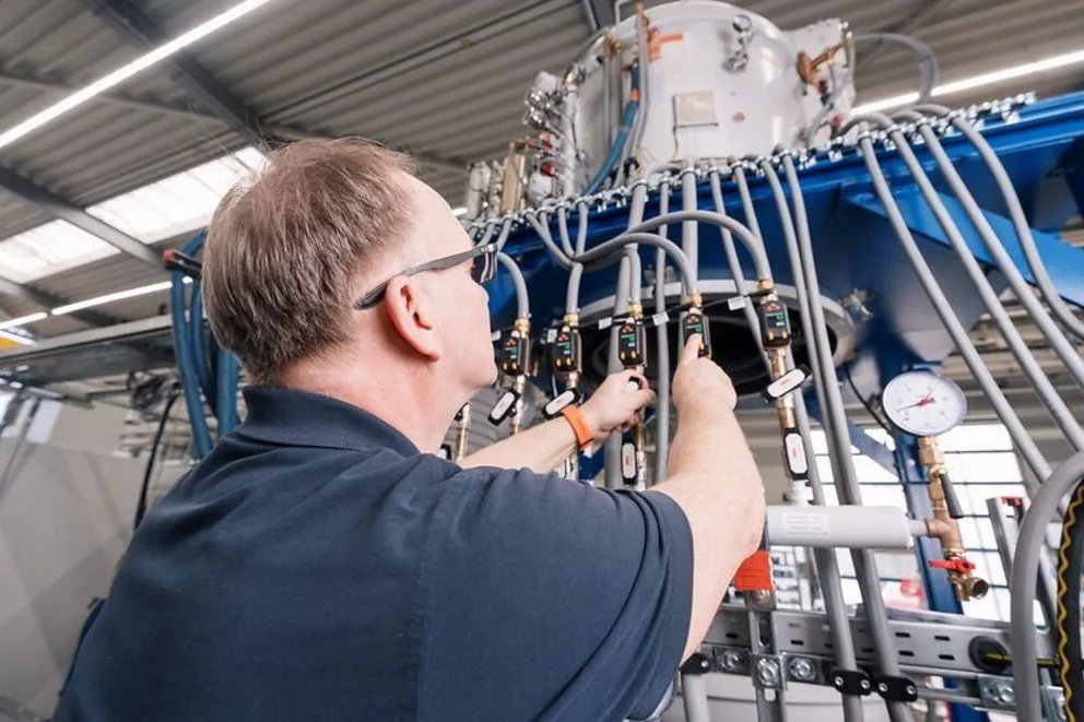 Worker adjusts components