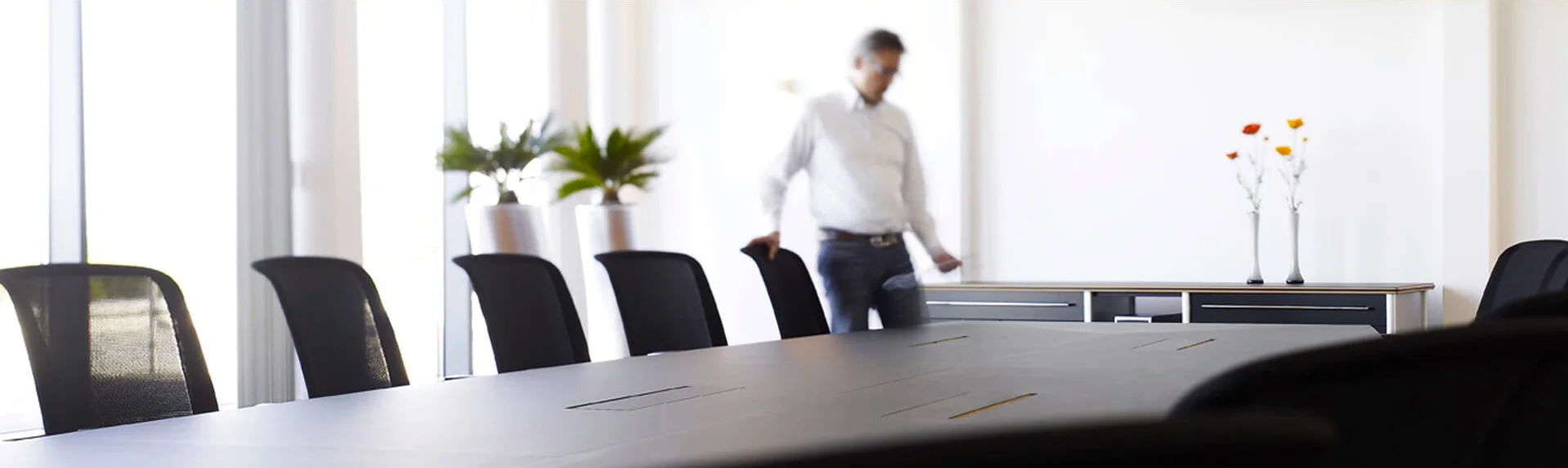 Person standing in a conference room.