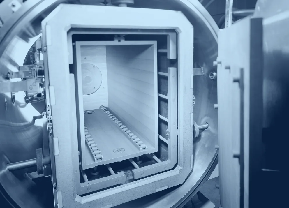 Industrial sintering furnace with an open cylindrical chamber and visible internal heating components