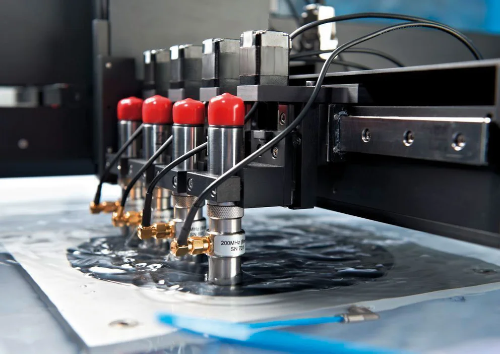 Array of scanning acoustic microscopy (SAM) transducers aligned above a sample surface for high‑precision, non‑destructive inspection.